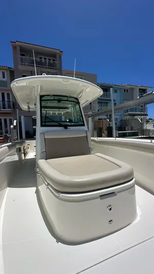  Yacht Photos Pics 2017 Boston Whaler 330 Outrage boat with cushioned seating, docked near waterfront homes.