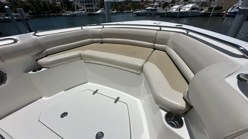  Yacht Photos Pics 2017 Boston Whaler 330 Outrage boat interior with cushioned seating and cup holders.