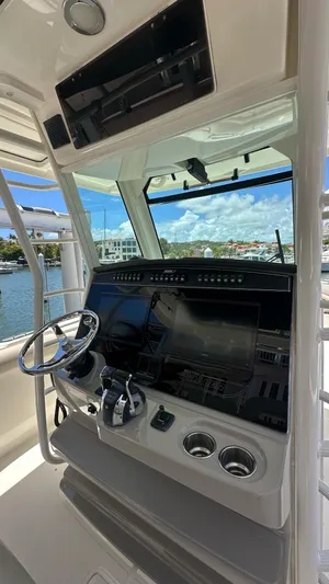  Yacht Photos Pics 2017 Boston Whaler 330 Outrage helm with modern controls and navigation system.