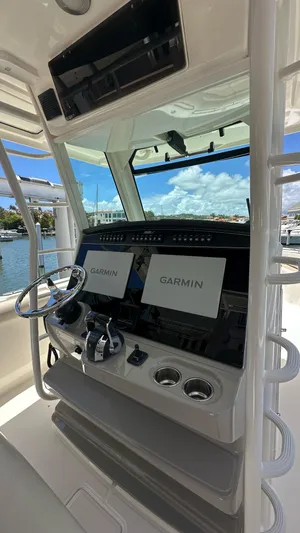  Yacht Photos Pics 2017 Boston Whaler 330 Outrage helm with Garmin navigation system, docked by the water.