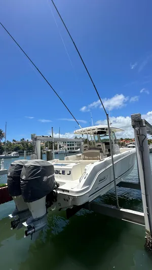  Yacht Photos Pics 2017 Boston Whaler 330 Outrage boat docked under clear blue sky.