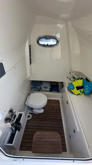  Yacht Photos Pics 2017 Boston Whaler 330 Outrage cabin interior with toilet and storage space.