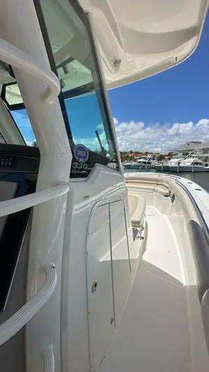  Yacht Photos Pics 2017 Boston Whaler 330 Outrage boat docked under clear blue sky.