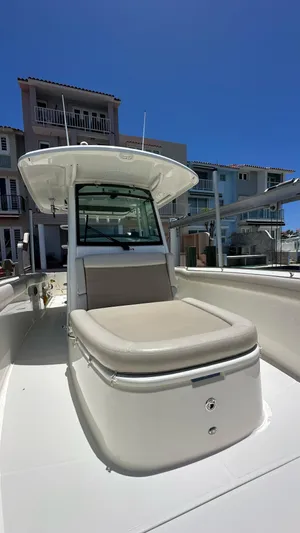  Yacht Photos Pics 2017 Boston Whaler 330 Outrage boat with cushioned seating, docked near waterfront homes.