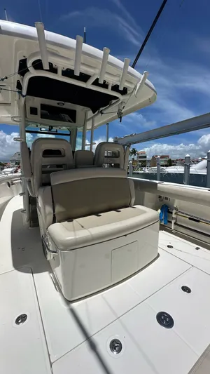  Yacht Photos Pics 2017 Boston Whaler 330 Outrage boat interior with seating and rod holders under a clear sky.
