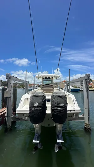  Yacht Photos Pics 2017 Boston Whaler 330 Outrage boat docked with twin engines, under a clear blue sky.