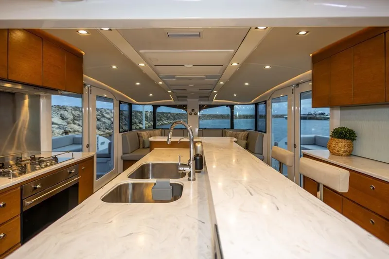 Katari Yacht Photos Pics Luxurious yacht interior with modern kitchen, marble countertops, and panoramic ocean views. Tag 60, 2018 model.