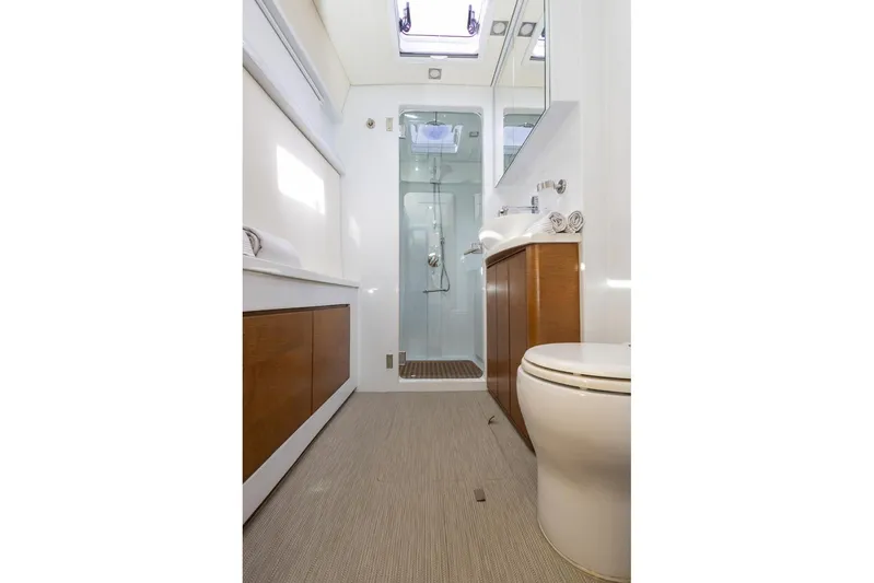 Katari Yacht Photos Pics Modern yacht bathroom with shower, wooden cabinets, and skylight, Tag 60 model, 2018.