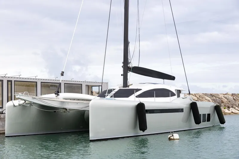 Katari Yacht Photos Pics 2018 Tag 60 catamaran docked in marina, featuring sleek design and modern architecture.