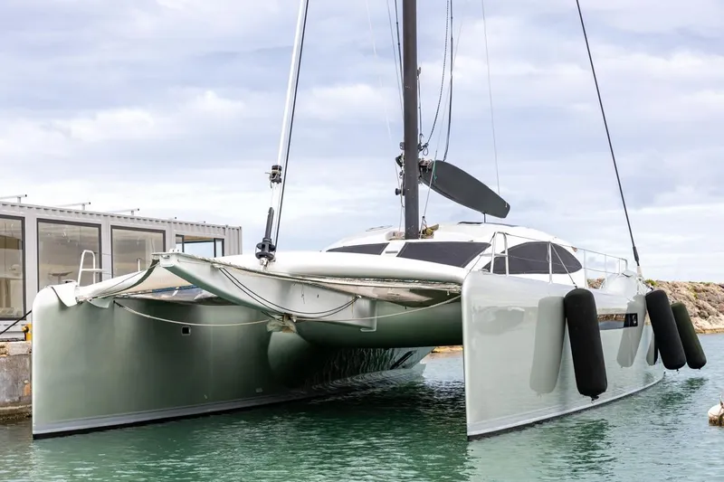 Katari Yacht Photos Pics 2018 Tag 60 catamaran docked, featuring sleek design and modern architecture.