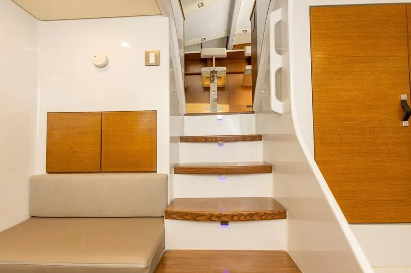 Katari Yacht Photos Pics Interior of 2018 Tag 60 yacht with wooden stairs and seating area.