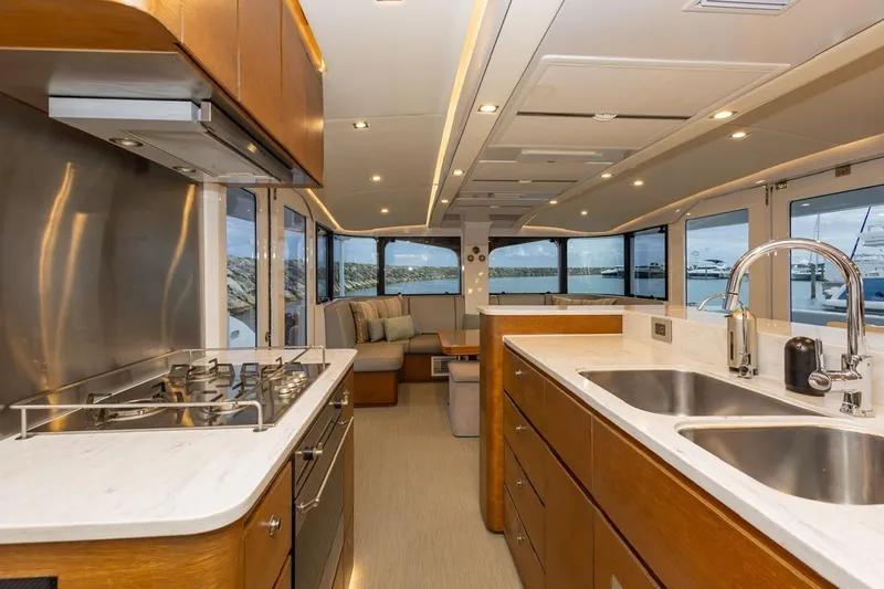 Katari Yacht Photos Pics Luxurious yacht interior with modern kitchen, dual sinks, and scenic ocean views. Tag 60, 2018 model.