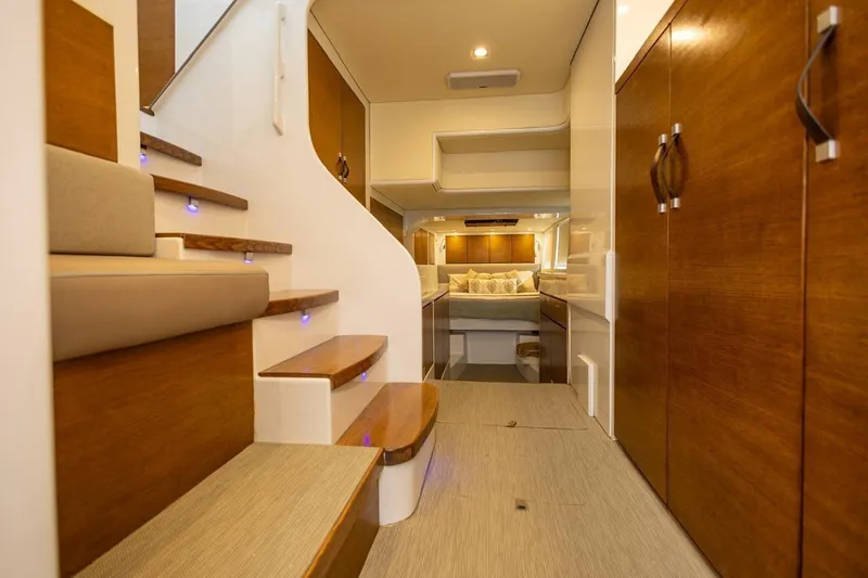 Katari Yacht Photos Pics Luxurious yacht interior with wooden finishes, modern staircase, and cozy bedroom, Tag 60 model, 2018.