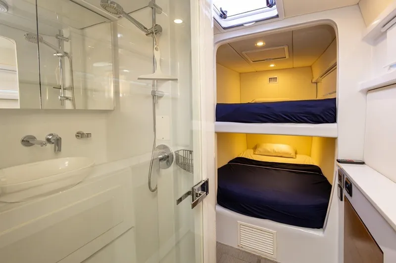 Katari Yacht Photos Pics Compact yacht interior with bunk beds and modern bathroom, Tag 60 model, 2018.