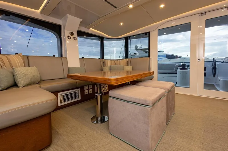 Katari Yacht Photos Pics Luxurious yacht interior with plush seating and wooden table, Tag 60 model, 2018.