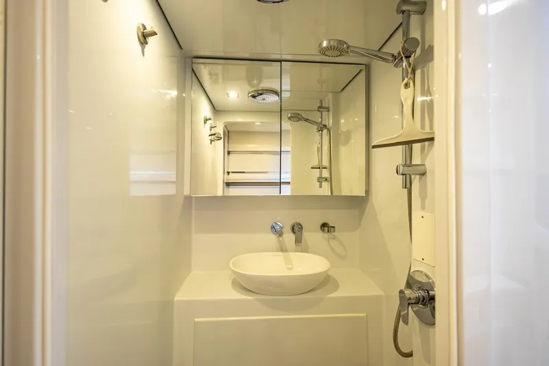 Katari Yacht Photos Pics Modern bathroom with sleek fixtures, mirror, and shower in a 2018 Tag 60 model.
