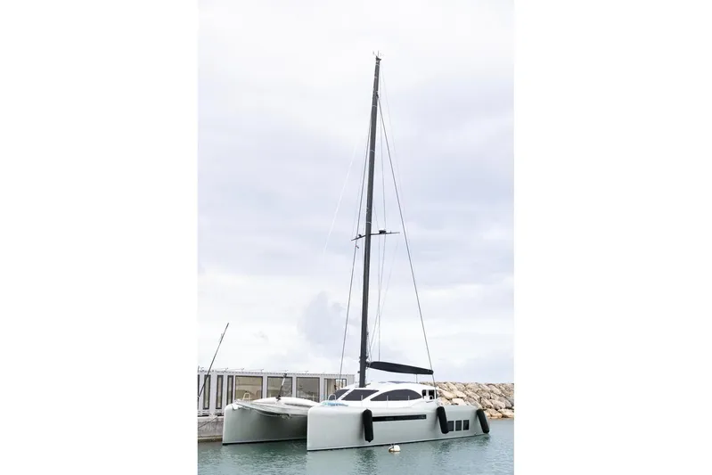 Katari Yacht Photos Pics 2018 Tag 60 catamaran docked at marina under cloudy sky.