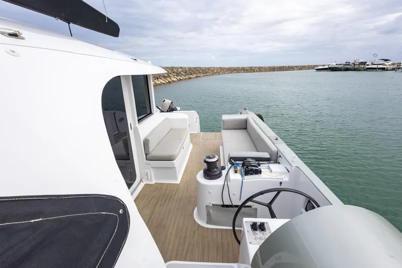Katari Yacht Photos Pics Modern Tag 60 boat interior with seating, steering wheel, and ocean view, 2018 model.