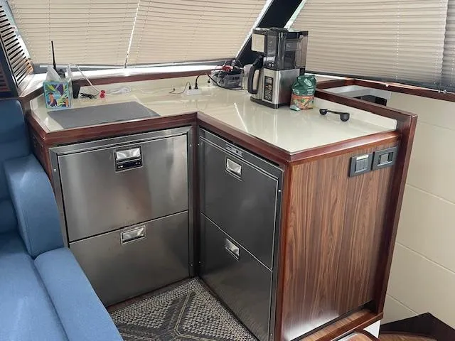 Honey Ryder Yacht Photos Pics Modern kitchen area in a 2022 HH Catamarans 50, featuring stainless steel appliances.