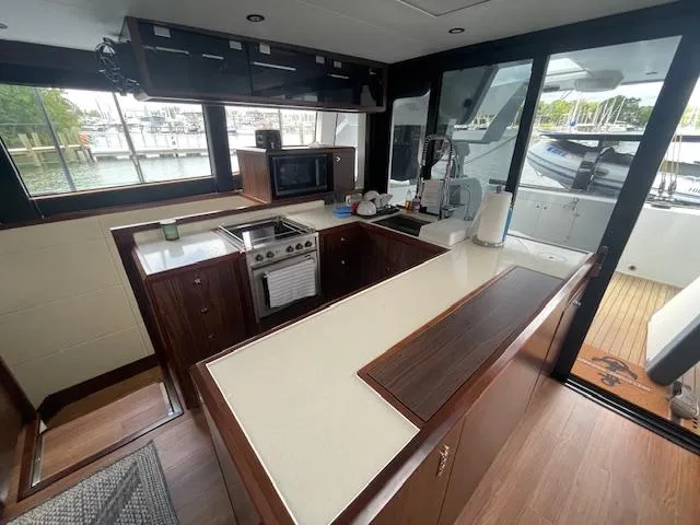 Honey Ryder Yacht Photos Pics Modern kitchen interior of 2022 HH Catamarans 50, featuring sleek countertops and appliances.