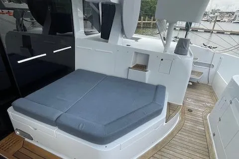 Honey Ryder Yacht Photos Pics 2022 HH Catamarans 50 deck with cushioned seating and wooden flooring.