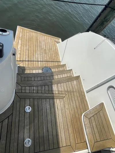 Honey Ryder Yacht Photos Pics Teak deck steps on 2022 HH Catamarans 50, leading to water.