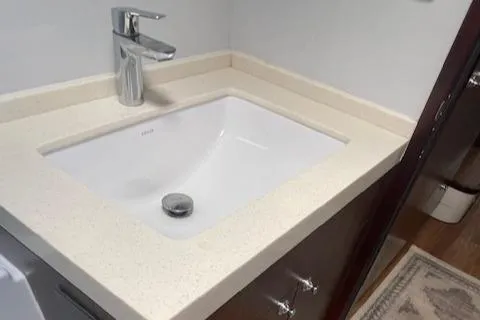 Honey Ryder Yacht Photos Pics Modern bathroom sink in 2022 HH Catamarans 50 yacht, featuring sleek faucet and countertop.