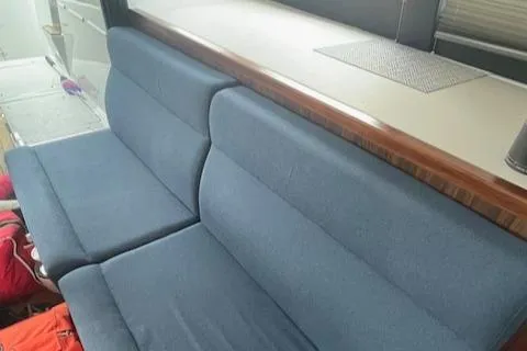 Honey Ryder Yacht Photos Pics Interior seating of 2022 HH Catamarans 50, featuring blue upholstery and wooden accents.