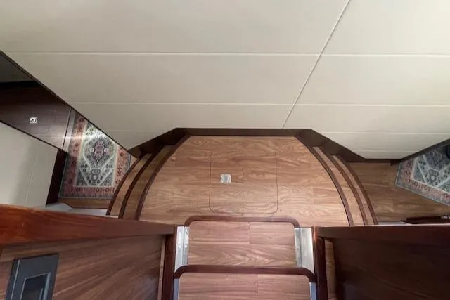 Honey Ryder Yacht Photos Pics Interior of 2022 HH Catamarans 50, featuring wood flooring and decorative rugs.
