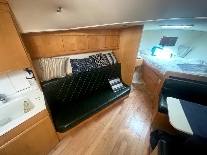  Yacht Photos Pics Interior of 1998 Hatteras 39 Sport Express with seating, bed, and kitchenette.