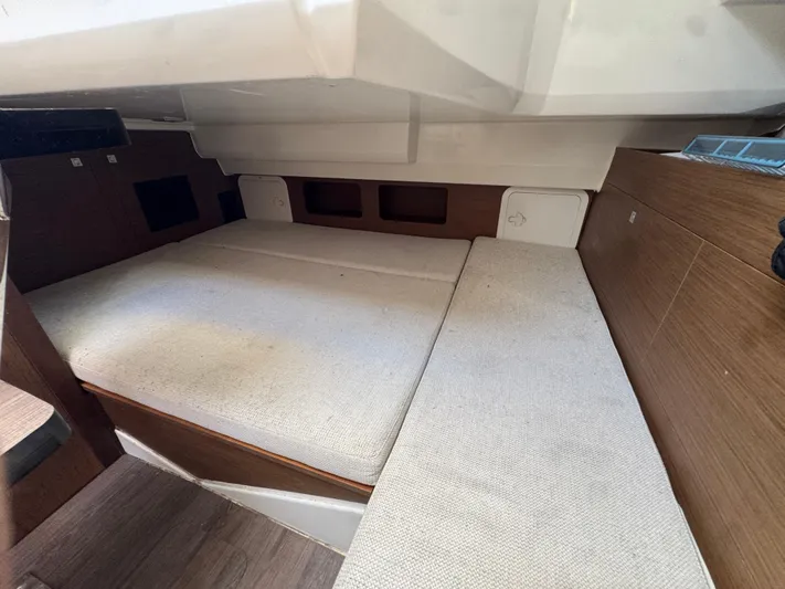  Yacht Photos Pics 2020 Jeanneau Leader 9.0 WA cabin interior with cushioned seating and wooden accents.