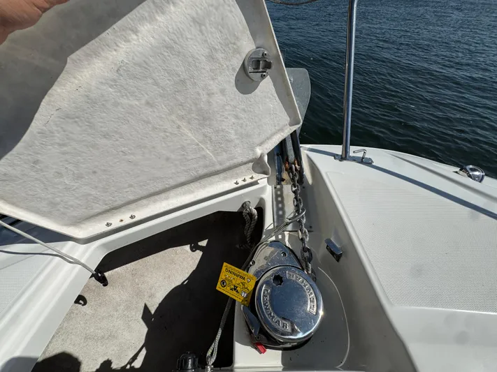  Yacht Photos Pics 2020 Jeanneau Leader 9.0 WA anchor compartment with open hatch, showing anchor chain and winch.