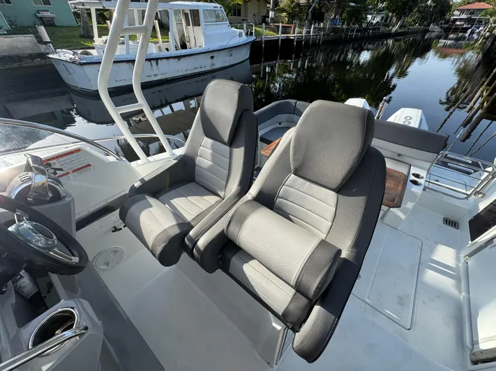  Yacht Photos Pics 2020 Jeanneau Leader 9.0 WA boat with dual captain seats, docked by a canal.