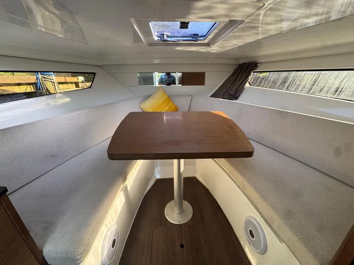  Yacht Photos Pics Interior of 2020 Jeanneau Leader 9.0 WA boat with cozy seating and table.