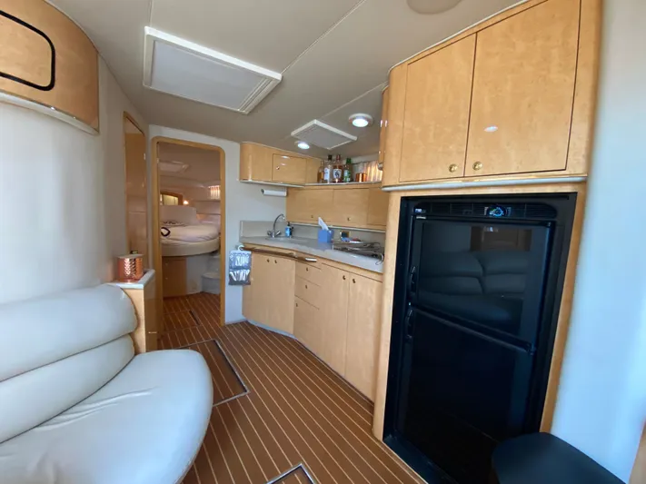  Yacht Photos Pics Interior of 1997 Sea Ray 450 Sundancer yacht with kitchen and seating area.