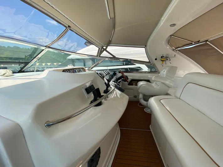  Yacht Photos Pics 1997 Sea Ray 450 Sundancer yacht interior with white seating and control panel.