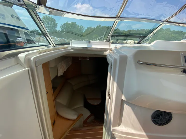  Yacht Photos Pics 1997 Sea Ray 450 Sundancer interior view with seating and open cabin door.