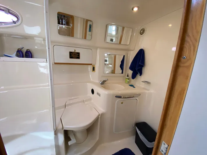  Yacht Photos Pics Bathroom interior of a 1997 Sea Ray 450 Sundancer yacht, featuring a sink and toilet.