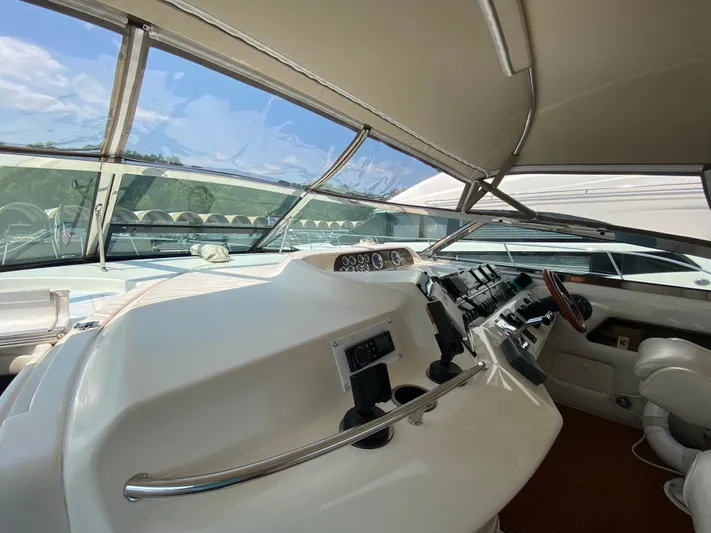  Yacht Photos Pics 1997 Sea Ray 450 Sundancer helm with modern controls and panoramic windshield view.
