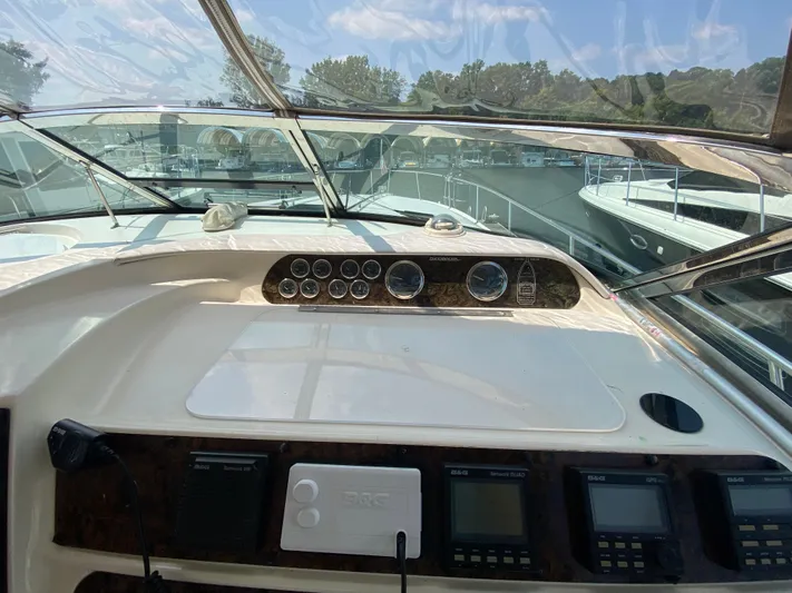  Yacht Photos Pics 1997 Sea Ray 450 Sundancer helm with gauges and navigation equipment, docked at marina.