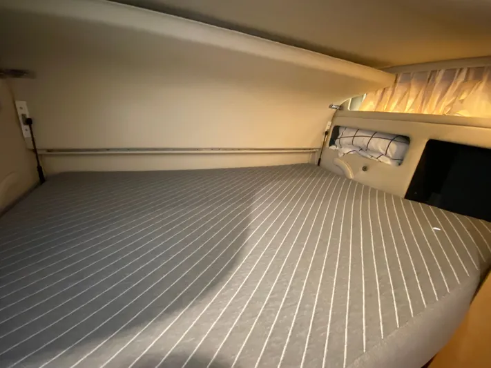  Yacht Photos Pics Cozy cabin interior of 1997 Sea Ray 450 Sundancer yacht with striped bedding.