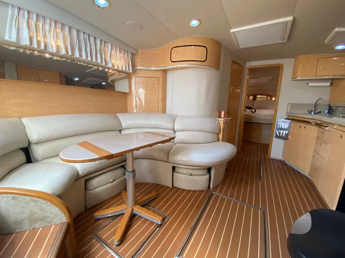  Yacht Photos Pics Luxurious interior of 1997 Sea Ray 450 Sundancer yacht with leather seating and wooden flooring.