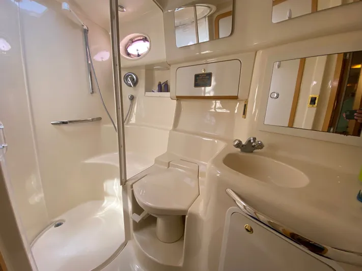  Yacht Photos Pics Bathroom interior of 1997 Sea Ray 450 Sundancer yacht, featuring shower, sink, and toilet.
