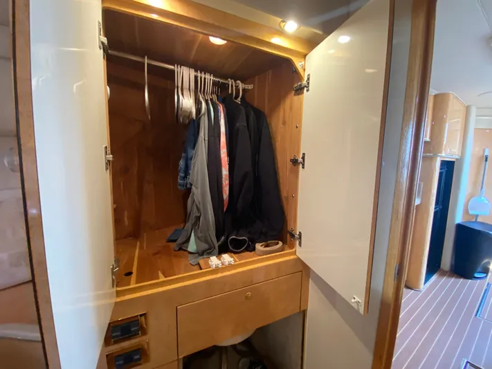  Yacht Photos Pics Closet interior on 1997 Sea Ray 450 Sundancer yacht with hanging clothes and accessories.