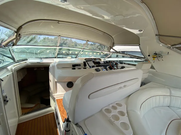  Yacht Photos Pics 1997 Sea Ray 450 Sundancer yacht interior with helm, seating, and cabin entrance.