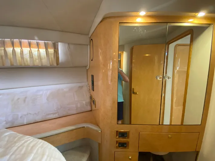  Yacht Photos Pics Interior of 1997 Sea Ray 450 Sundancer yacht with wood cabinetry and mirrored closet.