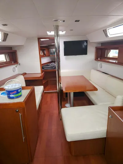 Far Star Yacht Photos Pics Interior of 2012 Beneteau Oceanis 41 sailboat with modern seating and wooden finishes.