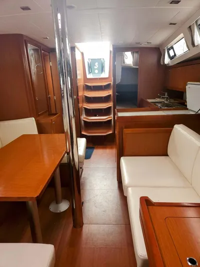 Far Star Yacht Photos Pics Interior of 2012 Beneteau Oceanis 41 sailboat with wood finish and seating area.