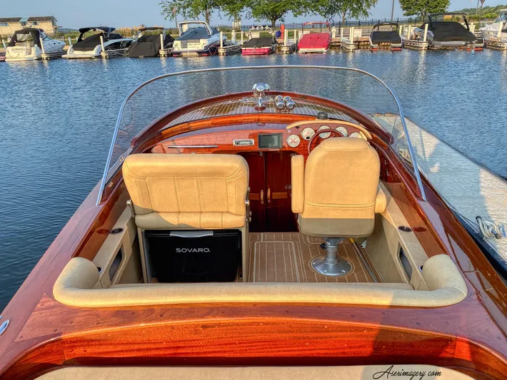  Yacht Photos Pics Custom 2020 Windlea Runabout boat interior at marina, featuring wooden finish and beige seats.