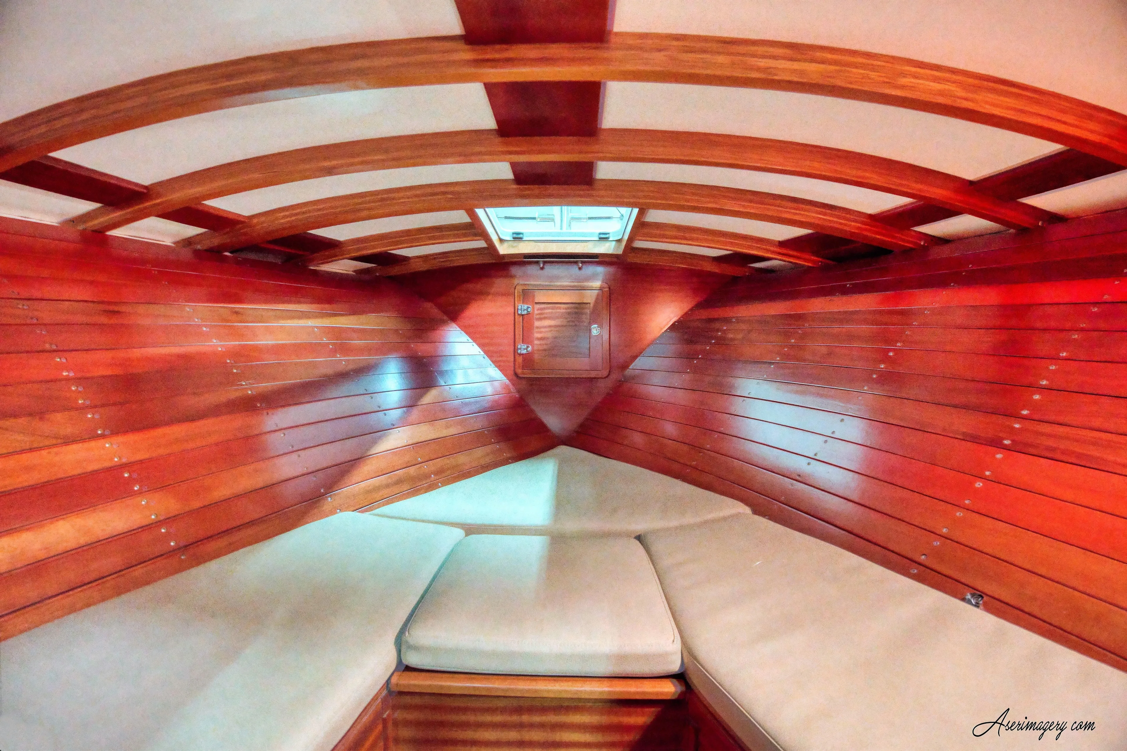  Yacht Photos Pics Interior of 2020 Custom Windlea Runabout boat with wooden finish and cushioned seating.